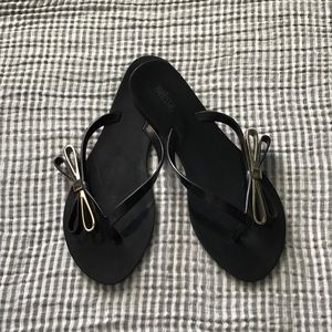 Melissa black sandals w/ gold bow accents